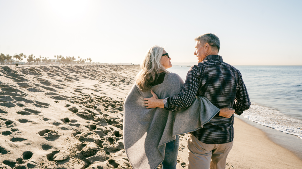 Picture of a mature couple walking on a beach